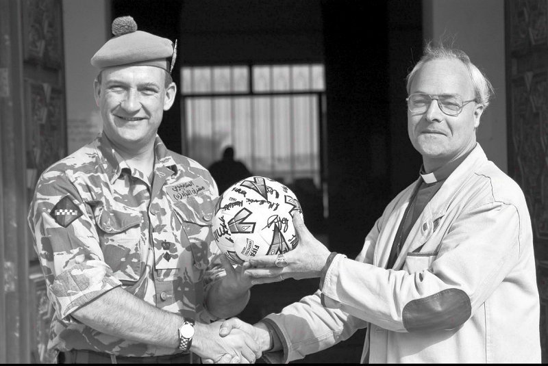 Iraq 2004: Being presented by the Moderator of the General Assembly of the CofS a football signed by the Scotland team.
